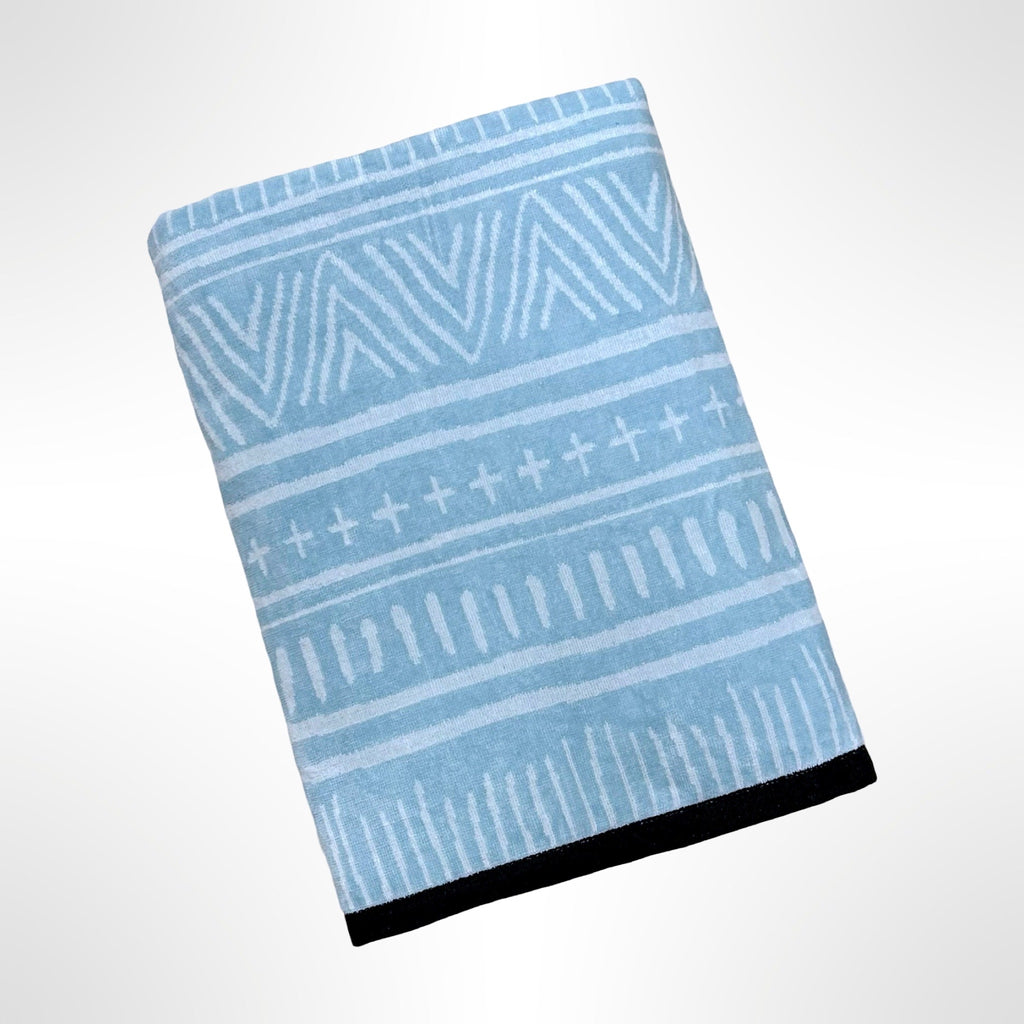 Large personalised beach towel with a white pattern on a light blue background.