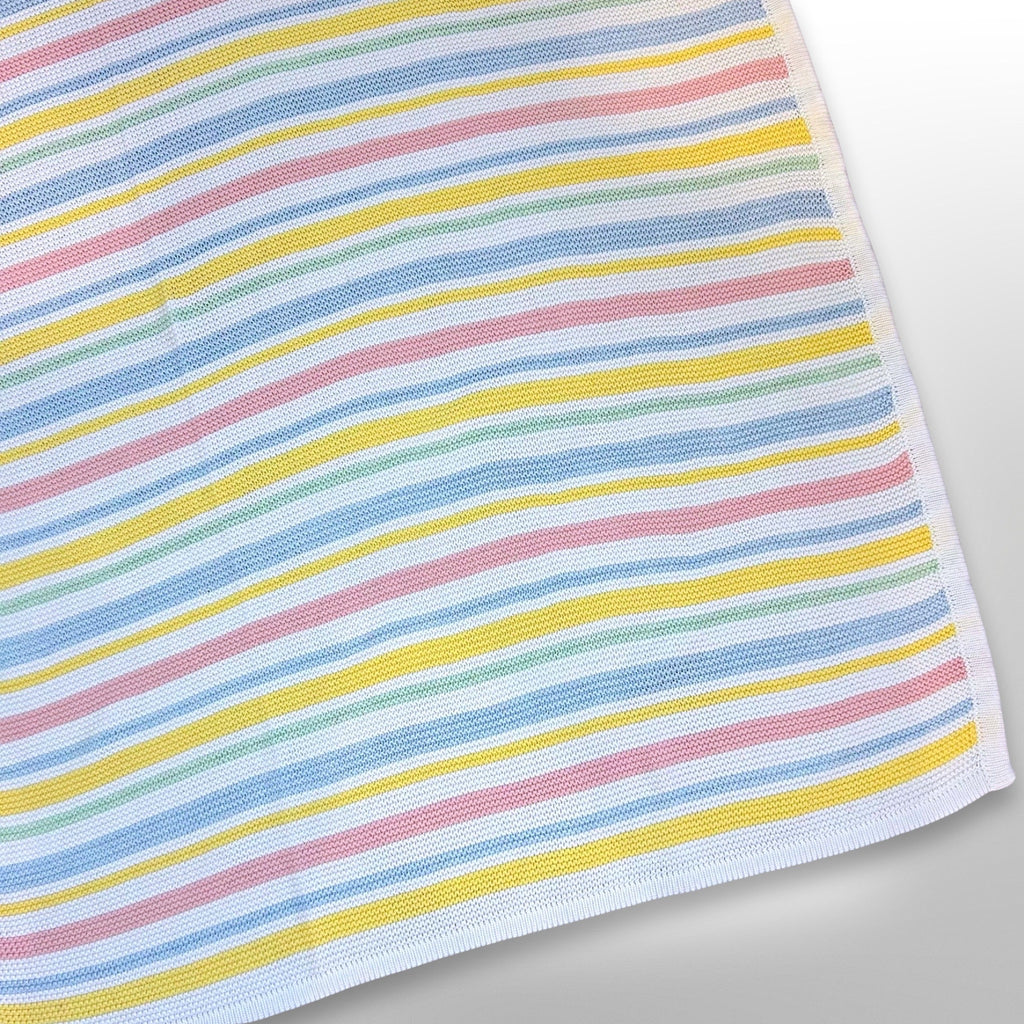 Knit blanket with pink, blue and yellow stripes alternating with white stripes, ready to be personalised with a name using embroidery.
