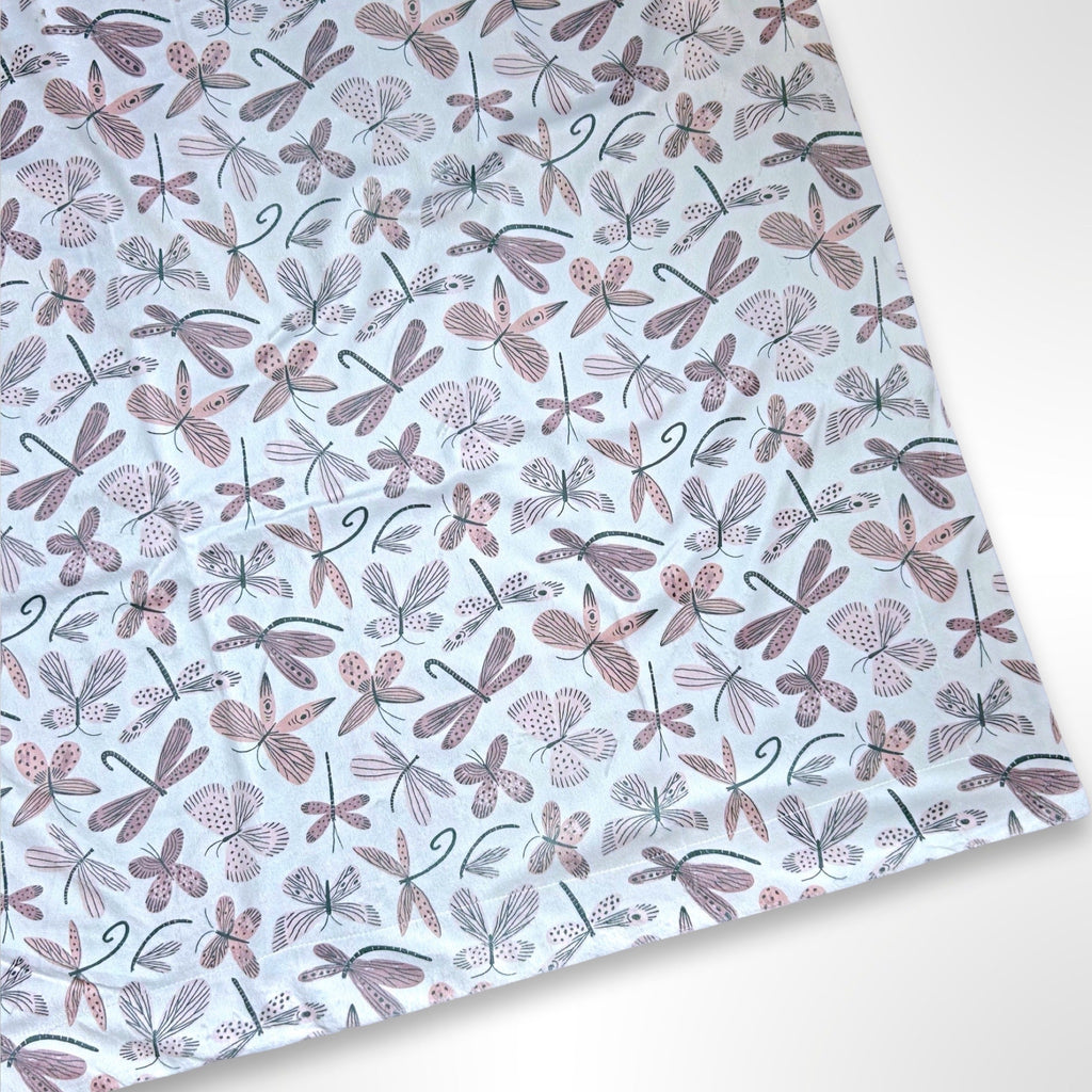 Double layer minky fleece blanket with a light pink butterfly and dragonfly pattern ready to be personalised with an embroidered name.