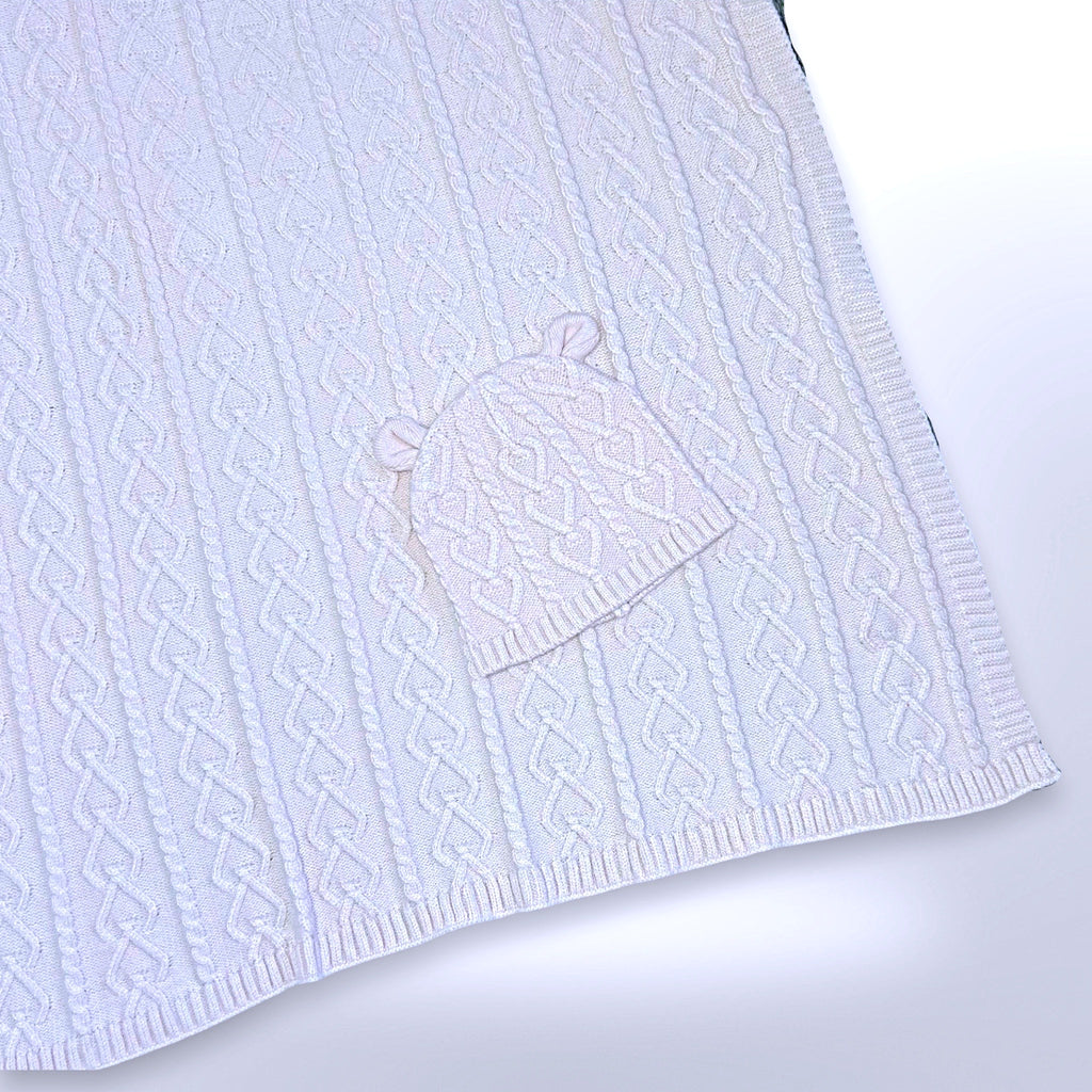 Pink personalised cable knit blanket with matching beanie hat, ready to be personalised with a name using embroidery.