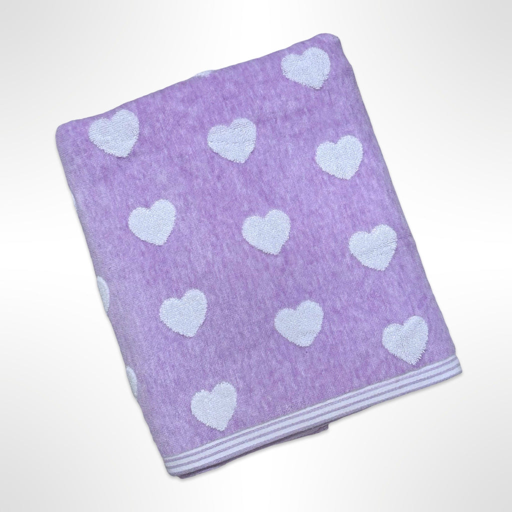 Personalised bath towel with small white hearts on a light purple background.