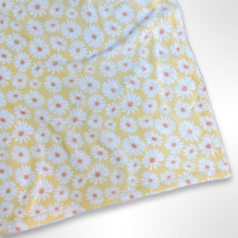 Double layer minky fleece blanket with white daisy flowers on a yellow background ready to be personalised with an embroidered name