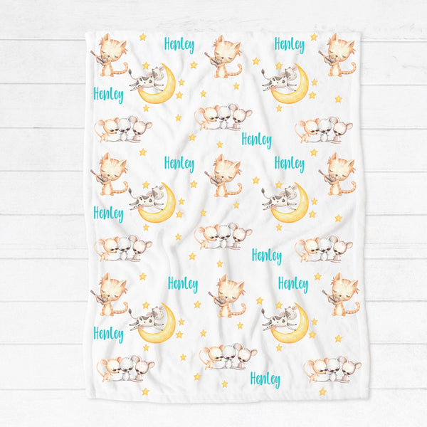 Personalised fleece minky blanket with the nursery rhyme characters of the cat playing the fiddle in hey diddle diddle, the cow jumping over the moon and three blind mice