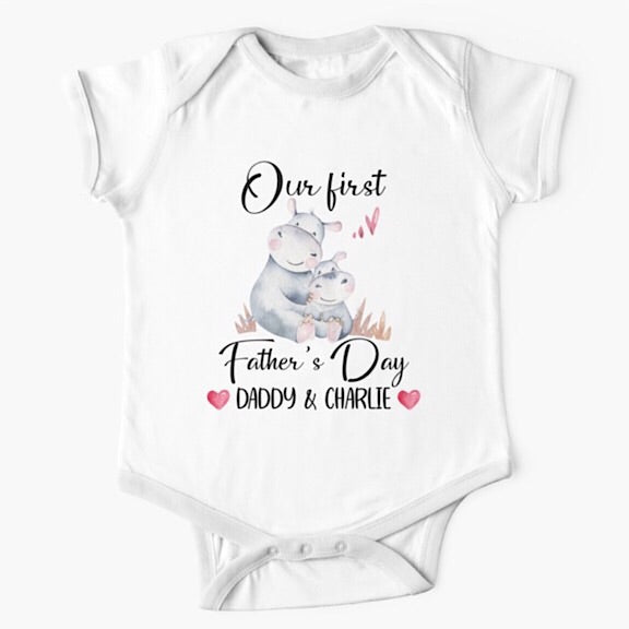 Personalised white short sleeved baby onesie bodysuit for daddys first fathers day with the names of both father and child combined with a watercolour painting of a daddy hippopotamus hugging a baby hippo