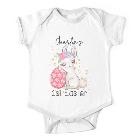 Short sleeved white baby onesie for a first easter with a sleepy bunny resting against an Easter egg  personalised with a name