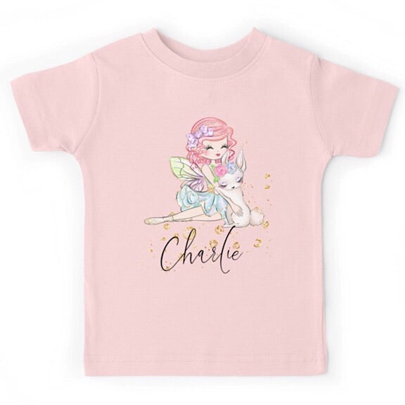 Light pink short sleeved tshirt with a fairy girl cuddling a white easter bunny, personalised with a name