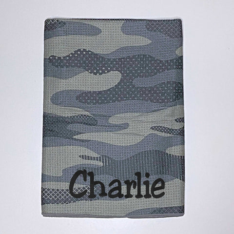 Beach towel in green camouflage colours personalised with a name.