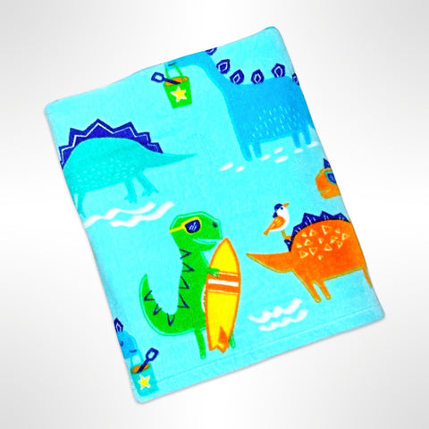 Children's personalised beach towel showing various dinosaurs ready for a day at the beach, on an aqua blue background.