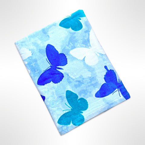 Children's personalised beach towel with blue, white and green butterflies on a watercolour blue background.
