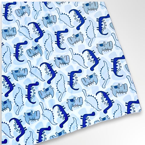 Minky blanket with blue dinosaurs on a white background, ready to be personalised with embroidery.