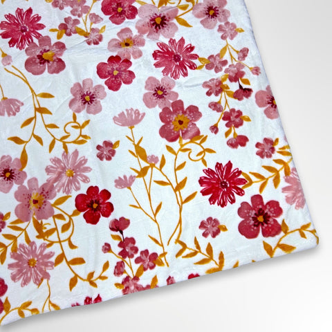 Minky blanket with pink, burgundy and mustard colours on a white background, ready to be personalised with a name in embroidery
