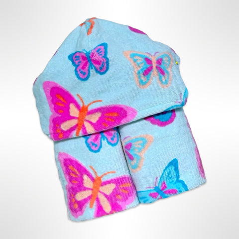 Personalised children's hooded beach towel that has bright pink and blue butterflies on a light blue background.