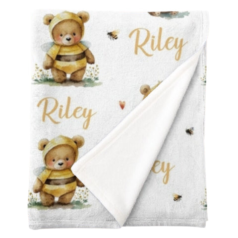 Personalised fleece minky blanket with cute teddies dressed up as bees surrounded by tiny bees and yellow hearts