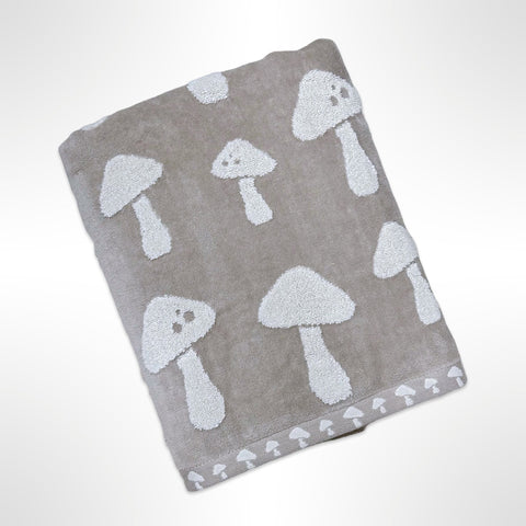 Personalised bath towel that has white mushrooms on a taupe background.