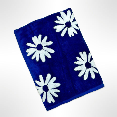 Personalised bath towel with white flowers on a dark blue background.