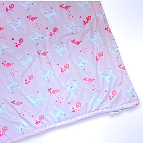 Minky blanket with deer and flowers on an apricot coloured background, ready to be personalised with a name.