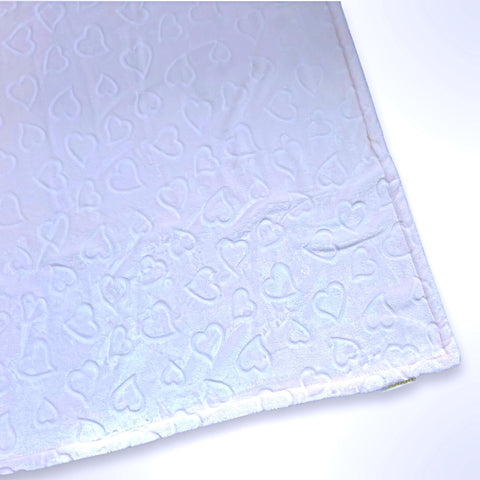 Minky blanket with embossed hearts on a pale pink background, ready to be personalised with a name.