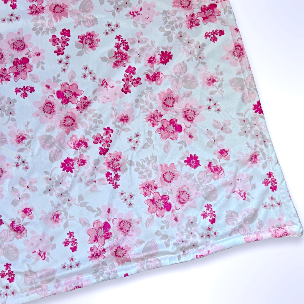 Double layer personalised minky blanket with pink flowers on a white background, ready to be personalised with a name using embroidery.