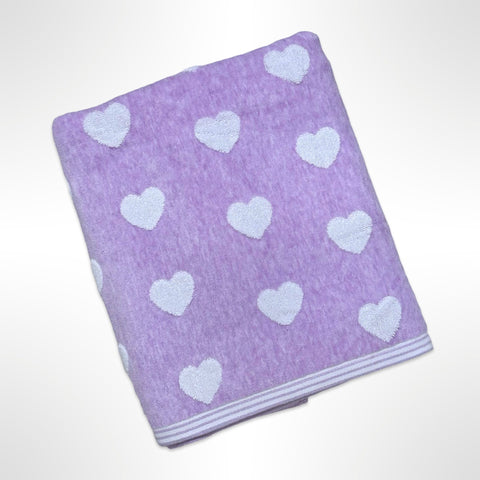 Personalised bath towel with small white hearts on a light purple background.