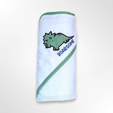 White personalised baby hooded towel - the hood has a picture of a green triceratops with the word ROARSOME in blue.