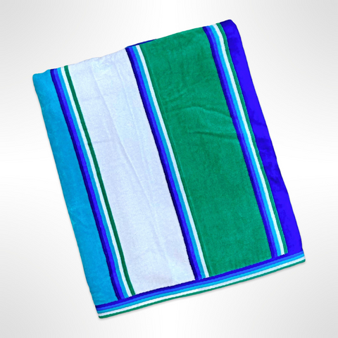 Large personalised beach towel that has stripes in varying shades of blue, green and white.