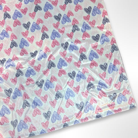 Minky blanket with pink, purple and grey coloured hearts on a white background, ready to be personalised with a name using embroidery