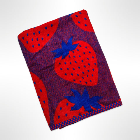 Large personalised beach towel with bright red strawberries on a navy blue background.