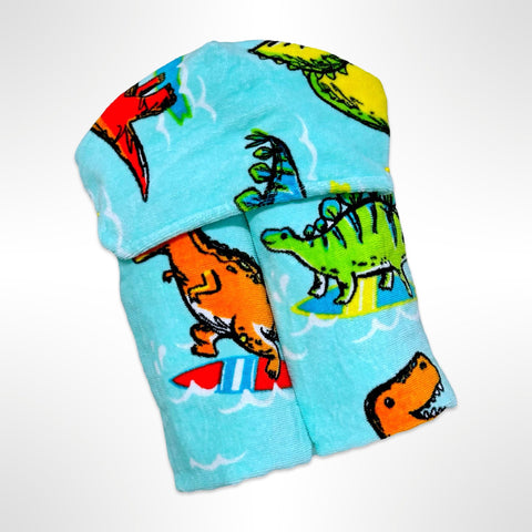 Personalised children's hooded beach towel that has brightly coloured dinosaurs surfing on surfboards in a light blue ocean.