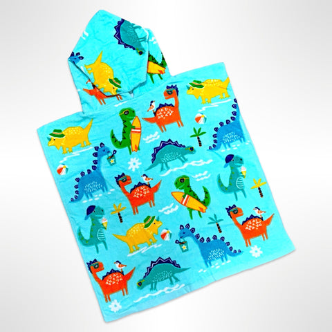Junior sized beach poncho covered in a variety of species of dinosaurs going to the beach and surfing, personalised with a name on the back.