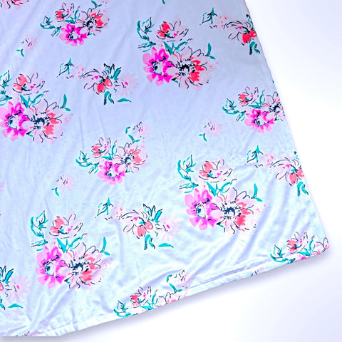 Minky blanket with pink and apricot flowers on a pale pink background, ready to be personalised with a name.