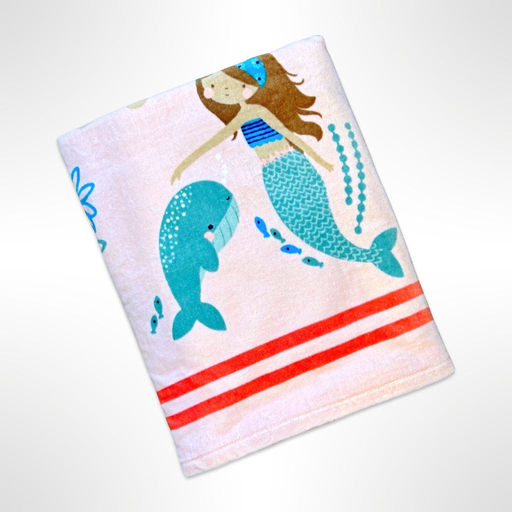 Large personalised beach towel with mermaids playing among sea creatures on a light pink background.