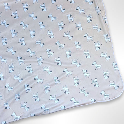 Double layer minky blanket with black and white zebras on a light brown background, ready to be personalised with a name using embroidery.