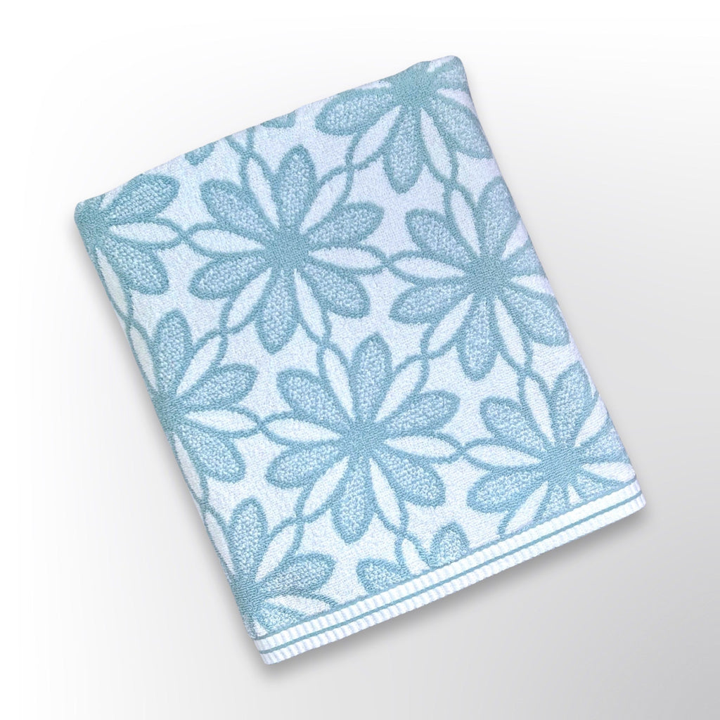 Personalised bath towel with a teal and white floral pattern.