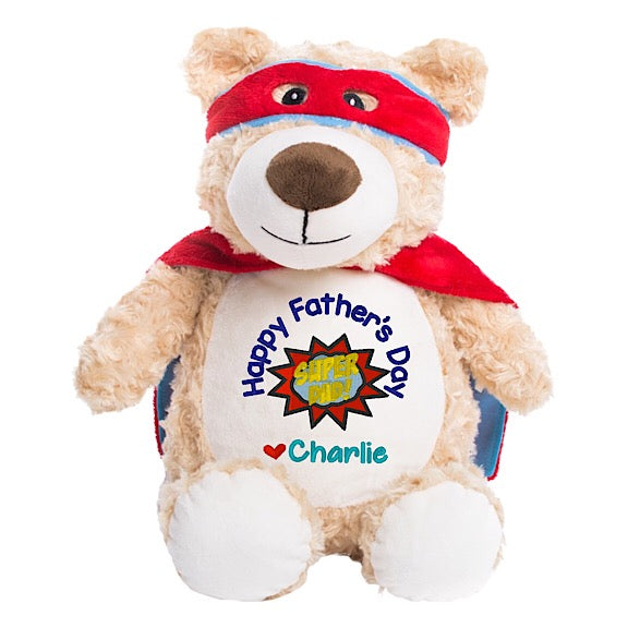 Light brown shaggy teddy bear plushie with red super hero cape and mask with white  belly embroidered with Happy Fathers Day Super Dad and personalised with children's names