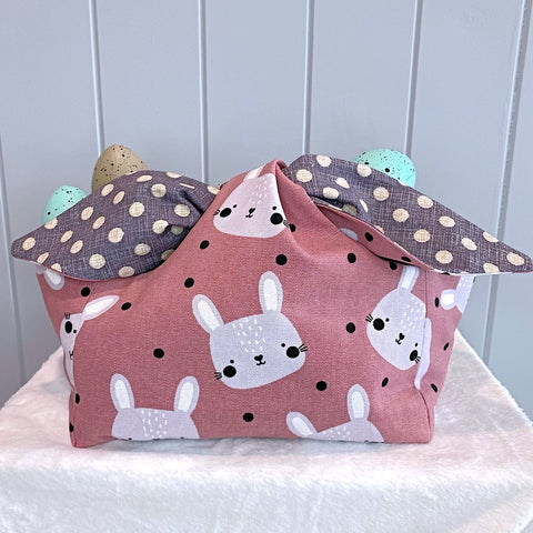 Handmade personalised easter basket bag with outer layer made out of grey cartoon bunny on a black spot background fabric and inner lining in a grey and cream spot fabric.