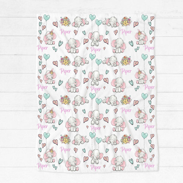 Personalised fleece minky blanket covered in grey floppy eared elephants in a variety of poses with bunches of flowers, pink and mint green hearts and mint green heart balloons