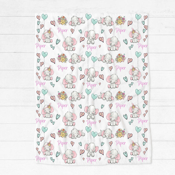 Personalised fleece minky blanket covered in grey floppy eared elephants in a variety of poses with bunches of flowers, pink and mint green hearts and mint green heart balloons