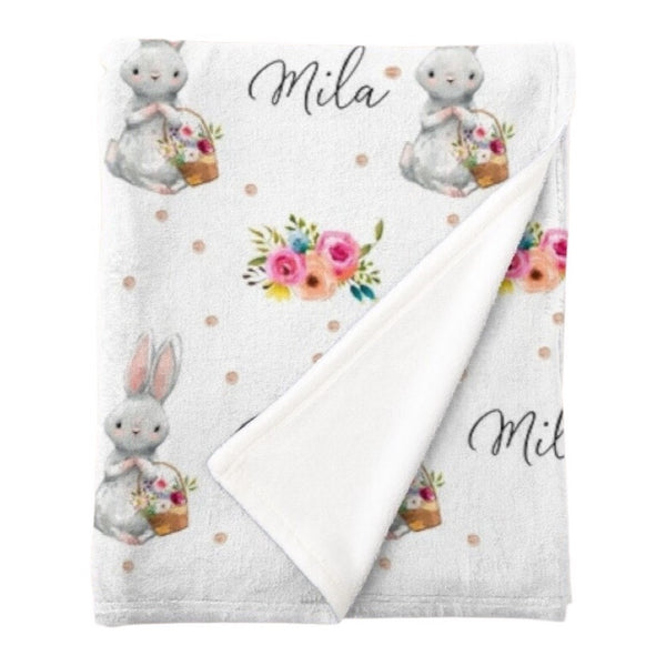 Personalised fleece minky blanket with a white bunny holding a basket full of flowers on a white background with gold spots