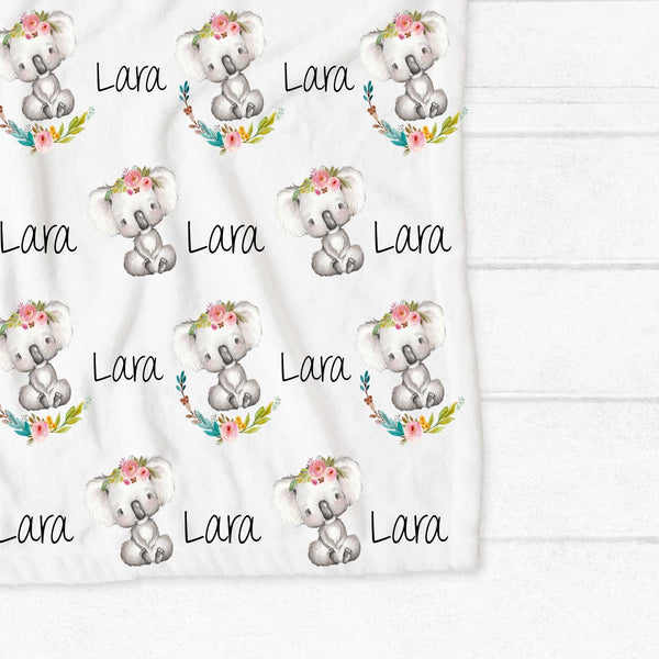 Personalised fleece minky blanket with a grey and white koala wearing a floral crown