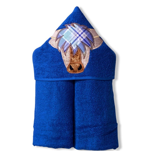 Hooded bath beach swim towel in blue with blue hood. Hood has the head of a highland Scottish cow in shades of brown and gold with a shock of tartan hair. Ready to be personalised.