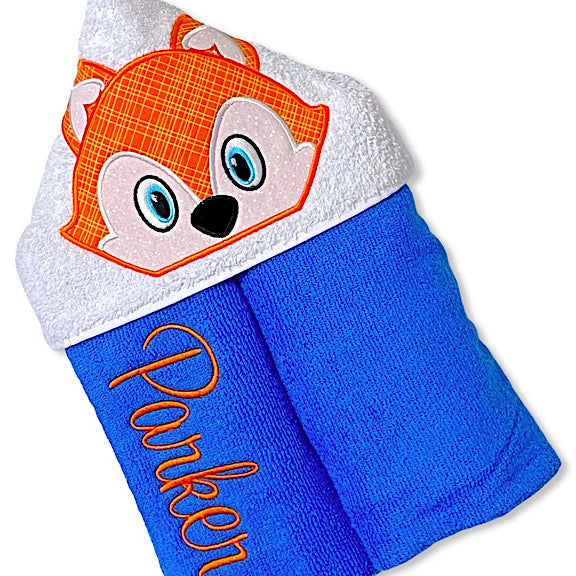 Hooded bath beach swim towel in blue with white hood. Hood has the face of orange and white fox appliquéd in the centre. Personalised with a name.