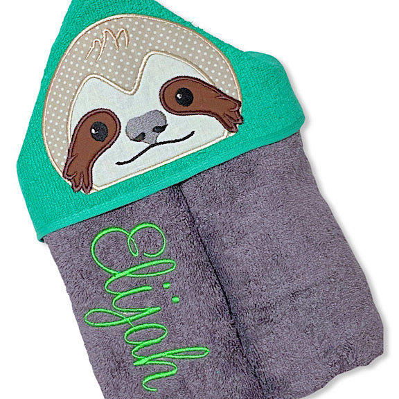 Hooded bath beach swim towel in grey with green hood. Hood has the face of a sleepy sloth appliquéd in the centre. Personalised with a name.