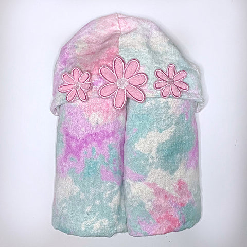 Children's hooded beach towel in shades of pink and blue tie dye, personalised with a name on the back.