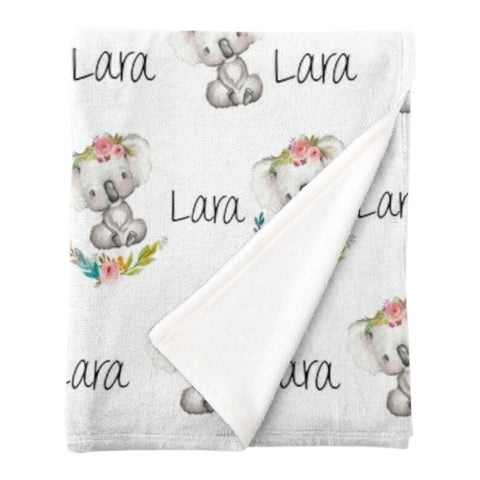 Personalised fleece minky blanket with a grey and white koala wearing a floral crown