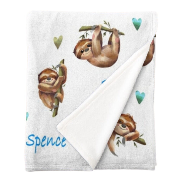 Personalised fleece minky blanket with sleepy sloths surrounded by blue and green hearts