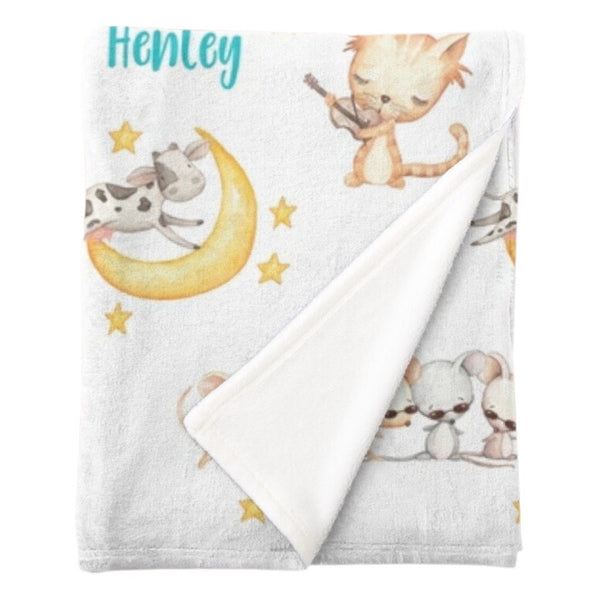 Personalised fleece minky blanket with the nursery rhyme characters of the cat playing the fiddle in hey diddle diddle, the cow jumping over the moon and three blind mice