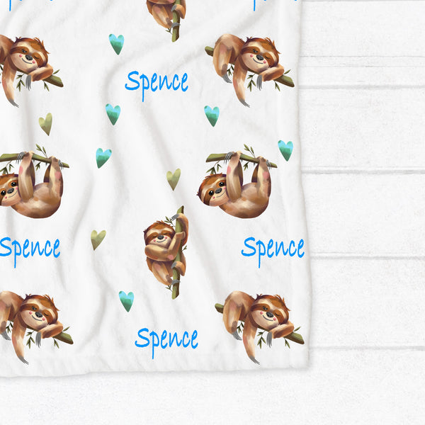 Personalised fleece minky blanket with sleepy sloths surrounded by blue and green hearts