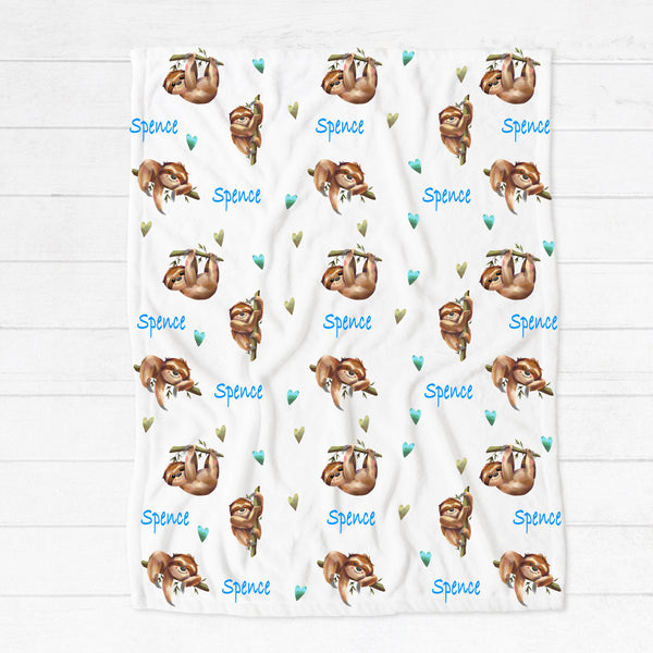 Personalised fleece minky blanket with sleepy sloths surrounded by blue and green hearts