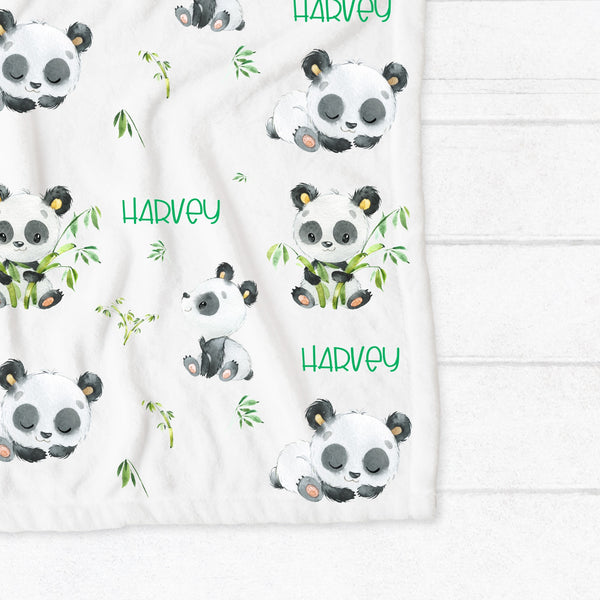 Personalised fleece minky blanket with a black and white panda in various positions eating bamboo