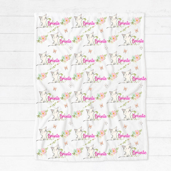 Personalised fleece minky blanket with grey and white kittens playing in a field of pink, blue and white flowers chasing pink and white butterflies